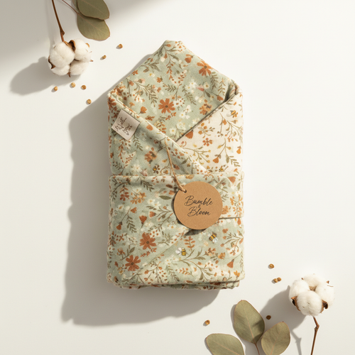 Folded organic cotton swaddle blanket with botanical print